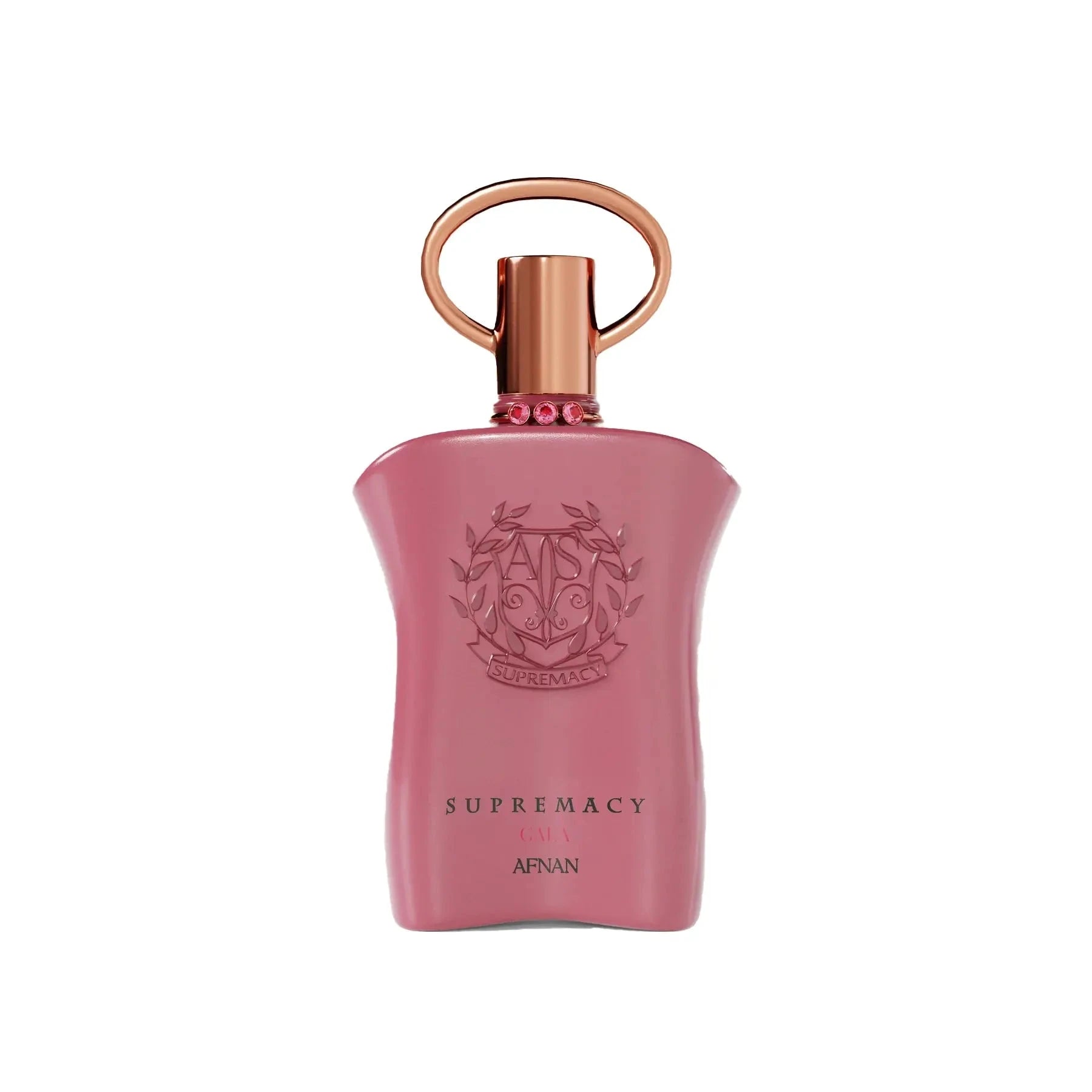 The image shows a pink perfume bottle with a metallic gold cap and a ring-shaped detail on top. The front of the bottle displays embossed text and a decorative emblem featuring the initials 'AP' in a stylized design, surrounded by a wreath-like motif. Below the emblem, the words "SUPREMACY GALA AFNAN" are printed in a simple, elegant font. The bottle has a smooth, matte finish, and there are small, pink gemstone-like embellishments around the neck.