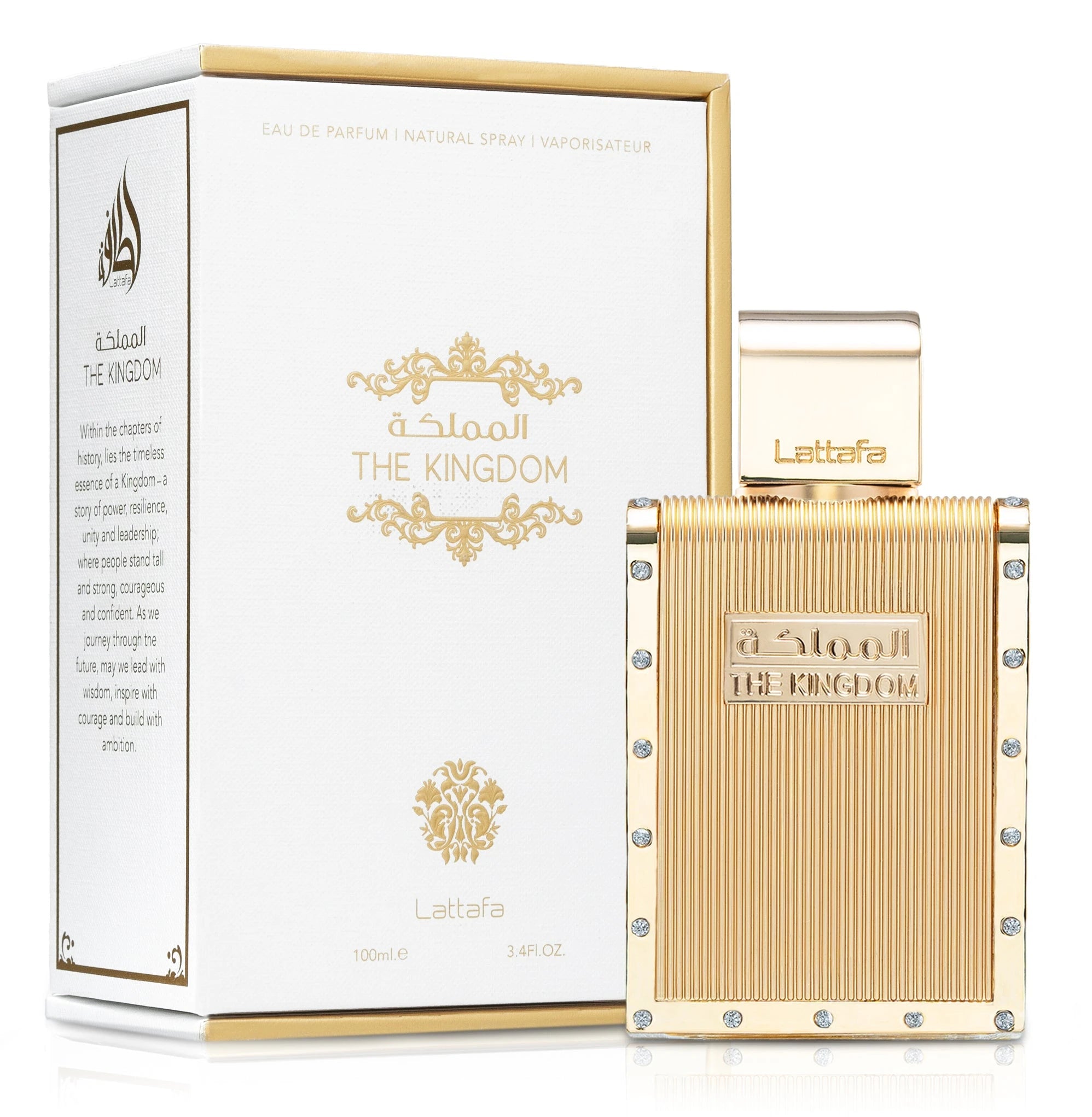 A rectangular gold perfume bottle, accented with vertical ridges and small round crystals along the edges, labeled “The Kingdom” in raised lettering. A matching gold cap features the Lattafa logo, and the bottle is displayed beside a white box embellished with gold flourishes, product details, and “THE KINGDOM” branding.
