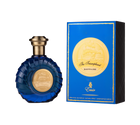 A round, deep-blue perfume bottle with a ridged design and a gold-toned cap, featuring a circular gold emblem depicting a ship on the front. It is displayed alongside a coordinating royal-blue rectangular box with gold trim and the same ship emblem, labeled “The Triumphant Sapphire” by Emir (100 ml Eau De Parfum).