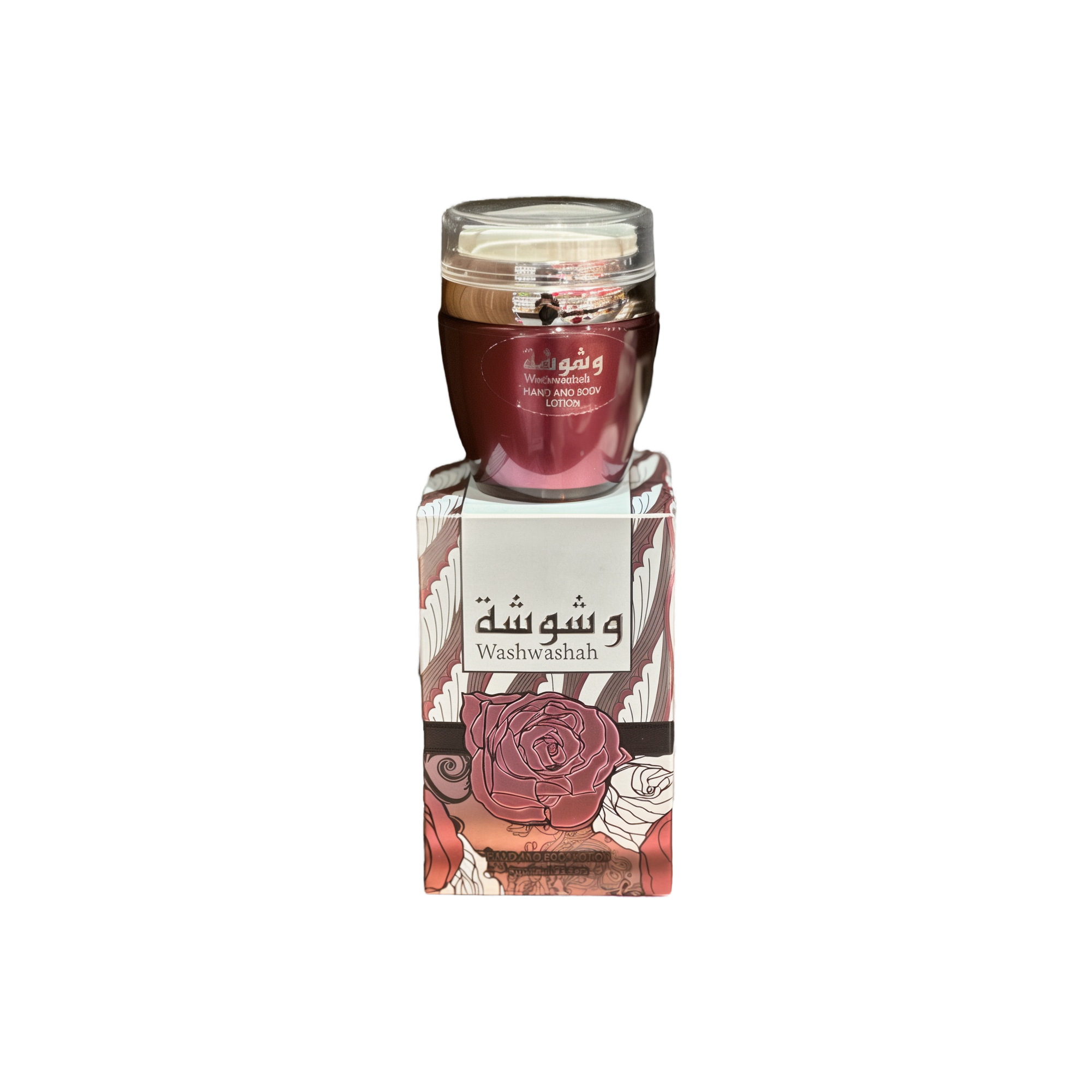The image shows a product named "Washwashah Hand and Body Lotion." The lotion comes in a dark red container with a clear lid and is placed on top of a matching red and beige box adorned with intricate floral patterns and Arabic calligraphy. The box prominently features the product name "Washwashah" along with an illustration of a rose. The elegant and artistic packaging suggests a luxurious and high-quality skincare product.
