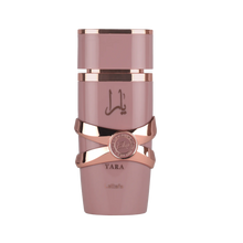 Lattafa Yara Elixir perfume bottle in dusty pink with rose gold accents and Arabic script, featuring a round emblem detail.