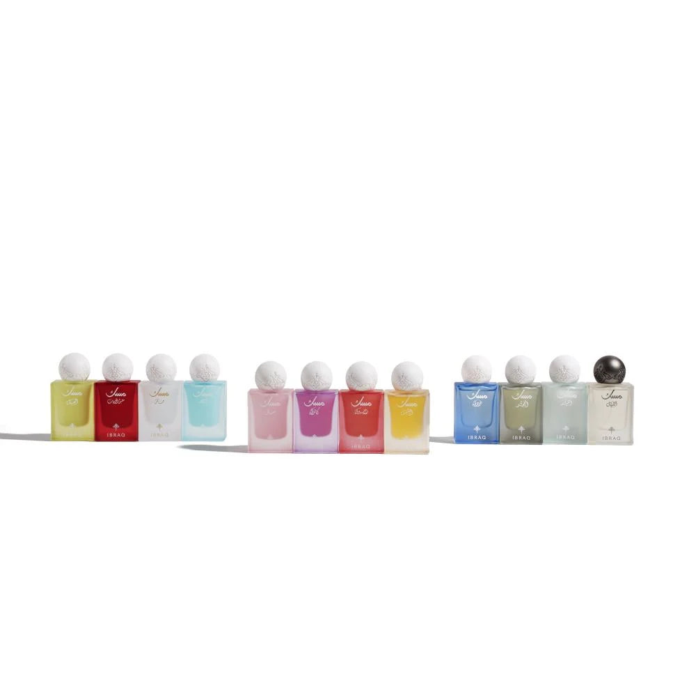 Row of small perfume bottles with white caps on a white background