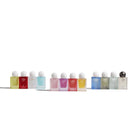 Row of small perfume bottles with white caps on a white background